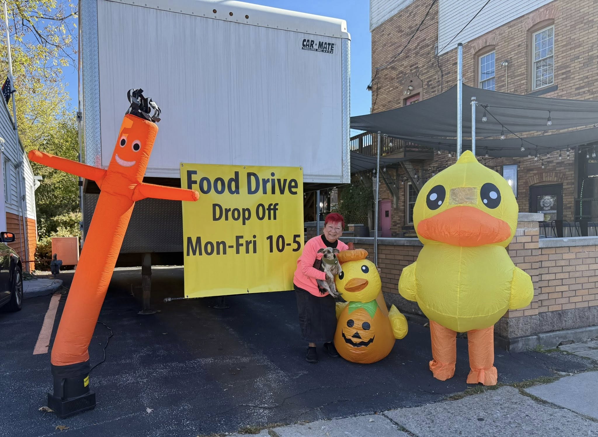 Debby McCain (and Eli) pose with duck mascots for the fall food drive in 2025